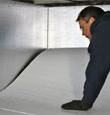contractor installing TerraBlock™ floor insulation in a Roseville crawl space