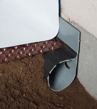 Closeup of a crawl space drainage system installed in Pleasanton