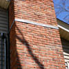 A tilting chimney on a Pittsburg home with a leaning, tilting chimney that was temporarily repaired.