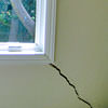 A long, diagonal crack that begins at a window corner of a Antioch home